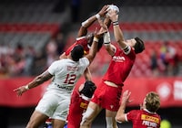 United States' Martin Iosefo (12) vies for the ball against Canada's Andrew Coe, right, and Josiah Morra, back, during HSBC Canada Sevens rugby action, in Vancouver, on September 18, 2021. THE CANADIAN PRESS/Darryl Dyck