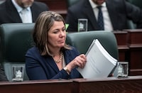 Alberta Premier Danielle Smith listens as Alberta Finance Minister Travis Toews delivers the 2023 budget, in Edmonton on Tuesday, February 28, 2023. THE CANADIAN PRESS/Jason Franson 