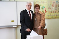 Presidential candidate Ivan Korcok with his wife Sona cast their votes a presidential runoff in Senec, Slovakia, Saturday, April 6, 2024. A pro-Western career diplomat and a close ally of Slovakia’s populist Prime Minister Robert Fico are facing each other in a presidential runoff on Saturday to determine who will be the next head of state. (AP Photo/Petr David Josek)