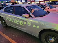 A Durham Regional Police car is shown at a Bowmanville, Ont. shopping centre parking lot on Tuesday Feb. 28, 2023. Police say a pursuit that began with a call about a robbery in a community northeast of Toronto has ended with a deadly crash. THE CANADIAN PRESS/Doug Ives