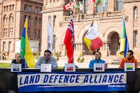 Members of the Land Defence Alliance, left to right, Cecilia Begg from Kitchenuhmaykoosib Inninuwug, Chief Chris Moonias of Neskantaga First Nation, Chief Rudy Turtle of Grassy Narrows First Nation and deputy chief Stanley Anderson of Wapekeka First Nation sit at a formal table set up outside the Legislature ready to meet with Premier Ford seeking his signature on a declaration of respect for their rights on the lawn of Queen's Park in Toronto on Tuesday, September 26, 2023. THE CANADIAN PRESS/Carlos Osorio