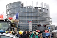 Farmers gather outside the European Parliament for a protest, in Strasbourg, eastern France, Tuesday, Feb. 6, 2024. The European Union's executive on Tuesday shelved its anti-pesticides proposal in yet another concession to farmers after weeks of protests blocked major capital and economic lifelines across the bloc. (AP Photo/Jean-Francois Badias)