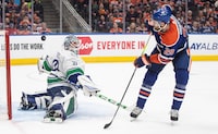 Vancouver Canucks goalie Arturs Silovs (31) makes the save on Edmonton Oilers' Leon Draisaitl (29) during second period second-round NHL playoff action in Edmonton, Sunday, May 12, 2024. THE CANADIAN PRESS/Jason Franson 