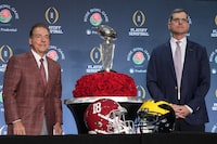 Dec 31, 2023; Los Angeles, CA, USA; Alabama Crimson Tide head coach Nick Saban (left) and Michigan Wolverines head coach Jim Harbaugh pose with the Leishman Trophy at the Rose Bowl coaches press conference at the Sheraton Grand  Mandatory Credit: Kirby Lee-USA TODAY Sports