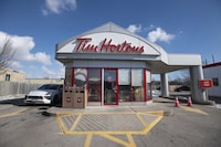 Vehicles line up at the Tim Horton drive thru shop on the Third Line on Dorval Rd. in Oakville, Ont. on Feb 15, 2022. Fred Lum 