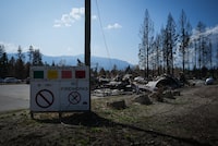 A sign warning of the level of fire danger is seen in front of the burned remains of the Scotch Creek – Lee Creek fire department and community hall, in Scotch Creek, B.C., Wednesday, Sept. 6, 2023. THE CANADIAN PRESS/Darryl Dyck