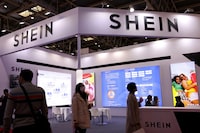 FILE PHOTO: People walk past the booth of fashion retailer Shein during the first China International Supply Chain Expo (CISCE) in Beijing, China November 28, 2023. REUTERS/Florence Lo/File Photo