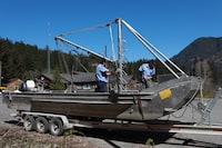 Deckhands from the Homalco First Nations ready a seine boat out front of the Ehattesaht First Nation's band office in Zeballos, B.C., Thursday, April 18, 2024. The arrival of a large seine fishing vessel capable of casting a net strong enough to hold an almost 700 kilogram killer whale calf has arrived in Zeballos, B.C. to participate in the expected latest attempt to rescue a young orca stranded in a remote tidal lagoon. THE CANADIAN PRESS/Chad Hipolito