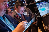Traders work on the floor of the New York Stock Exchange (NYSE) on March 20.