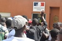 Protesters gather in front of the French Embassy in Niamey during a demonstration that followed a rally in support of Niger's junta in Niamey on July 30, 2023. Niger's junta on Sunday said ECOWAS could stage an imminent military intervention in the capital Niamey as the regional body meets for an "extraordinary summit" on the coup-hit country, with sanctions a possibility. The country's elected president Mohamed Bazoum has been held by the military for four days, and General Abdourahamane Tiani, the chief of the powerful presidential guard, has declared himself leader. (Photo by AFP) (Photo by -/AFP via Getty Images)