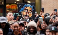 An image of the late rapper and actor Tupac Shakur appears among fans during a ceremony honoring Shakur with a star on the Hollywood Walk of Fame on Wednesday, June 7, 2023, in Los Angeles. (AP Photo/Chris Pizzello)