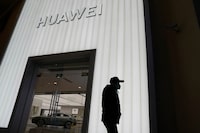 The University of Waterloo says it will end its research partnership with Huawei. A man is silhouetted outside a Huawei retail store in Beijing, Friday, Dec. 30, 2022. THE CANADIAN PRESS/AP-Ng Han Guan