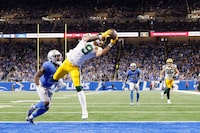 Green Bay Packers wide receiver Christian Watson (9) makes a reception for a td against the Detroit Lions in the second half of an NFL football game at Ford Field in Detroit, Thursday, Nov. 23, 2023. (AP Photo/Rick Osentoski)