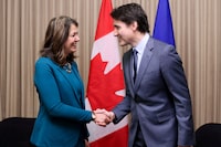 Canada's Prime Minister Justin Trudeau shakes hands with Alberta Premier Danielle Smith during a meeting in Calgary, Alberta, Canada, March 13, 2024. REUTERS/Dave Chidley NO RESALES. NO ARCHIVES