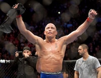 Georges St-Pierre, from Montreal celebrates after defeating Josh Koscheck, from Waynesburg, PA., with a unanimous decision to retain his welterweight title at UFC 124 on December 12, 2010 in Montreal. Canadian Georges St-Pierre, who ruled the UFC welterweight division before punctuating his stellar career by winning the middleweight title in his final outing, is headed to the UFC Hall of Fame. THE CANADIAN PRESS/Ryan Remiorz