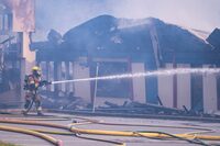 Police say they believe a fire last October that destroyed an elementary school in Port Coquitlam was human caused. Fire crews work to put out the fire at Hazel Trembath Elementary School in Port Coquitlam B.C., on Saturday, Oct. 14, 2023. THE CANADIAN PRESS/Ethan Cairns