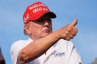 Republican presidential candidate former President Donald Trump gives a thumbs up as he watches play on the 18th hole green during the final round of LIV Golf Miami, at Trump National Doral Golf Club, Sunday, April 7 in Doral, Fla.