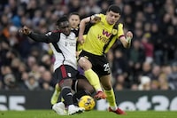 Fulham's Calvin Bassey vies for the ball with Burnley's Zeki Amdouni, right, during the English Premier League soccer match between Fulham and Burnley at Craven Cottage stadium in London, Saturday, Dec. 23, 2023. (AP Photo/Alastair Grant)