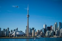 A neighbor of a beloved Toronto Islands clubhouse and cafe says the community will need time to process the loss after a fire destroyed that community hub over the weekend.The Toronto skyline is shown on June 21, 2018. THE CANADIAN PRESS/ Tijana Martin