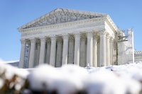 The U.S. Supreme Court is photographed through snow on Wednesday, Jan. 17, 2024, in Washington. (AP Photo/Mariam Zuhaib)