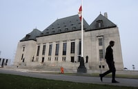 The Supreme Court of Canada will not hear a challenge of legislation that allows account information held by Canadian financial institutions to be shared with U.S. authorities. A man walks past the Supreme Court of Canada, Friday, June 16, 2023 in Ottawa. THE CANADIAN PRESS/Adrian Wyld