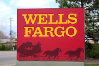 A sign stands outside a branch of Wells Fargo bank Wednesday, April 17, 2024, in Littleton, Colo. (AP Photo/David Zalubowski)