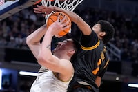 Purdue center Zach Edey is fouled by Grambling State guard Jimel Cofer, right, in the second half of a first-round college basketball game in the NCAA Tournament, Friday, March 22, 2024, in Indianapolis. (AP Photo/Michael Conroy)