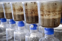 Tailings samples are being tested during a tour of Imperial's oil sands research centre in Calgary on Tuesday, Aug. 28, 2018. A Calgary-based lawyer says Alberta's energy regulator may have ignored provincial law by not publicly disclosing that waste from a large oilsands tailings pond was escaping containment and seeping into groundwater. THE CANADIAN PRESS/Jeff McIntosh