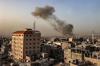 Smoke billows over buildings following Israeli bombardment in Rafah in the southern Gaza Strip on March 27, 2024, amid the ongoing conflict between Israel and the Palestinian militant group Hamas. (Photo by SAID KHATIB / AFP) (Photo by SAID KHATIB/AFP via Getty Images)