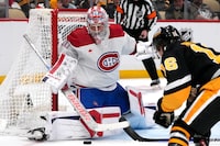 Montreal Canadiens goaltender Cayden Primeau (30) stops a shot attempt by Pittsburgh Penguins' Matthew Phillips (16) during the second period of an NHL hockey game in Pittsburgh, Thursday, Feb. 22, 2024. The Penguins won 4-1. (AP Photo/Gene J. Puskar)