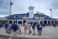 Fans wait to enter TD Ballpark before a spring training baseball game between the Toronto Blue Jays and the Philadelphia Phillies Monday, March 4, 2024, in Dunedin, Fla. (AP Photo/Charlie Neibergall)