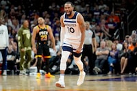 Minnesota Timberwolves guard Mike Conley (10) celebrates a basket against the Phoenix Suns during the second half of Game 3 of an NBA basketball first-round playoff series, Friday, April 26, 2024, in Phoenix. (AP Photo/Matt York)
