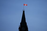 The Canada flag on the Peace Tower is lit up by morning light on Parliament Hill in Ottawa on Tuesday, May 9, 2023. A new poll suggests only one third of Canadians support the city of Mississauga, Ont., proposing to ask the Federal government to change the lyrics of the national anthem, O Canada. THE CANADIAN PRESS/Sean Kilpatrick
