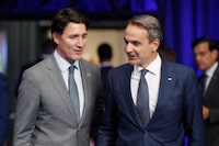 Canada's Prime Minister Justin Trudeau, left, speaks with Greek Prime Minister Kyriakos Mitsotakis during a round table meeting of the North Atlantic Council during a NATO summit in Vilnius, Lithuania, Tuesday, July 11, 2023. NATO's summit began Tuesday with fresh momentum after Turkey withdrew its objections to Sweden joining the alliance, a step toward the unity that Western leaders have been eager to demonstrate in the face of Russia's invasion of Ukraine. (AP Photo/Mindaugas Kulbis)