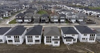 Homes under construction are seen in a suburb, Friday, Oct. 15, 2021 in Ottawa. The parliamentary budget officer says Canada would need to build 1.3 million additional homes by 2030 to eliminate the gap between housing demand and available supply. THE CANADIAN PRESS/Adrian Wyld
