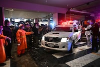 An ambulance leaves Siam Paragon shopping centre in Bangkok on October 3, 2023, following a shooting incident in the mall. One person was killed and six wounded in a shooting at a Bangkok mall, an emergency medical service said. Thai police have detained a 14-year-old boy over the shooting. (Photo by Lillian SUWANRUMPHA / AFP) (Photo by LILLIAN SUWANRUMPHA/AFP via Getty Images)