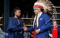 Manitoba Premier Wab Kinew greets Uzoma Asagwara, deputy premier, minister of Health, Seniors and Long-Term Care as Asagwara is sworn-in at a Premier and cabinet swearing-in ceremony in Winnipeg, Wednesday, Oct. 18, 2023. New security staff are scheduled to be in place at Manitoba's largest hospital on Monday in a bid to reduce violence. THE CANADIAN PRESS/John Woods