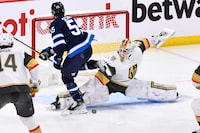 Vegas Golden Knights goaltender Laurent Brossoit (39) makes a save on Winnipeg Jets' Mark Scheifele (55) during first period game 4 NHL Stanley Cup first round hockey playoff action in Winnipeg, Monday April 24, 2023. The team's top goal-scorer, who left Monday’s 4-2 playoff loss to the Golden Knights with an upper-body injury, still remains a question mark for Thursday’s critical Game 5 with Vegas up 3-1 in the best-of-seven, first-round series. THE CANADIAN PRESS/Fred Greenslade