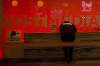 A security guard stands by the front reception desk at Postmedia's Toronto headquarters on Monday, March 12, 2018. Unifor says Postmedia has cut more than 75 jobs at the Windsor Star by outsourcing printing. The union says printing is being transferred to a Toronto printer, and the papers will then be shipped back to Windsor for distribution.THE CANADIAN PRESS/Chris Young