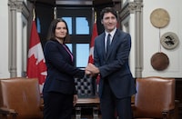 Prime Minister Justin Trudeau and Belarus opposition leader Sviatlana Tsikhanouskaya pose for cameras as they shake hands before a meeting, Monday, April 15, 2024 in Ottawa. THE CANADIAN PRESS/Adrian Wyld