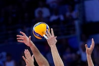 Players reach for the ball during the Men's European Volleyball final between Italy and Poland, in Rome, Saturday, Sept. 16, 2023. (AP Photo/Andrew Medichini)