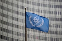 The flag of the International Atomic Energy Agency flies in front of its headquarters during an IAEA Board of Governors meeting in Vienna, Austria, Wednesday, Nov. 22, 2023. (AP Photo/Matthias Schrader)