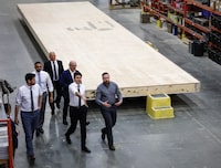 Prime Minister Justin Trudeau, second right, tours modular home construction facility before making a housing announcement in Calgary, Alta., Friday, April 5, 2024. THE CANADIAN PRESS/Jeff McIntosh
