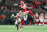 Calgary Stampeders' Rysen John (right) watches the ball sail past as BC Lions' Brooks Parker looks on during the second half of CFL pre-season football action in Vancouver, B.C., Thursday, June 1, 2023. THE CANADIAN PRESS/Rich Lam