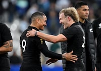 PARIS, FRANCE - OCTOBER 20: Damian McKenzie of New Zealand embraces teammate Aaron Smith following the team's victory during the Rugby World Cup France 2023 semi-final match between Argentina and New Zealand at Stade de France on October 20, 2023 in Paris, France. (Photo by Hannah Peters/Getty Images)