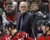 FILE - New Jersey Devils head coach Lindy Ruff, center, looks toward the ice during the third period of an NHL hockey game against the Carolina Hurricanes in Raleigh, N.C., Feb. 10, 2024. Ruff is returning to Buffalo for a second stint as coach of the Sabres. General manager Kevyn Adams announced the hiring Monday, April 22, 2024. (AP Photo/Ben McKeown, File)