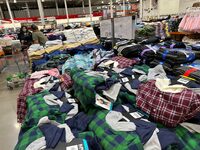 Shoppers peruse clothing on display in a Costco warehouse Wednesday, March 6, 2024, in Sheridan, Colo.