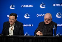 Francesco Aquilini, chairman and governor for the Vancouver Canucks, answers a question, as president of  hockey operations Jim Rutherford, listens, during a press conference at Rogers Arena in Vancouver, on Friday, January 19, 2024.  THE CANADIAN PRESS/ Tijana Martin