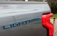 FILE PHOTO: The Lightning logo is seen on the side of an all-new Ford F-150 Lightning electric pickup truck outside the Ford Motor World Headquarters in Dearborn, Michigan, U.S., April 26, 2022. REUTERS/ Rebecca Cook/File Photo