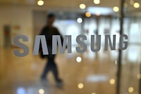 A man walks past the Samsung logo displayed on a glass door at the company's Seocho building in Seoul on April 5, 2024. Samsung Electronics said on April 5, it expects first-quarter operating profits to rise more than 10-fold year on year as chip prices recover. (Photo by Jung Yeon-je / AFP) (Photo by JUNG YEON-JE/AFP via Getty Images)
